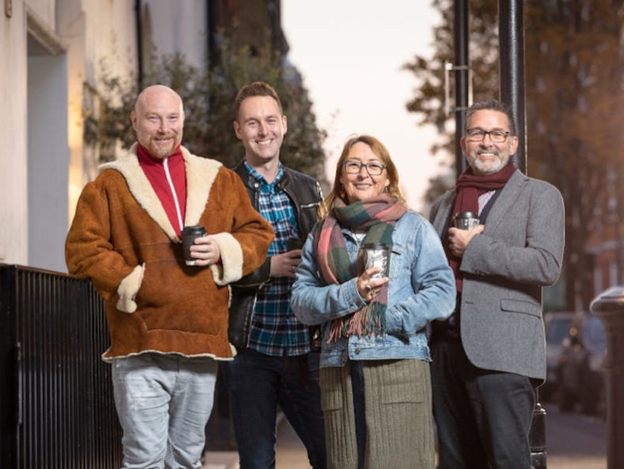 Four people outside smiling