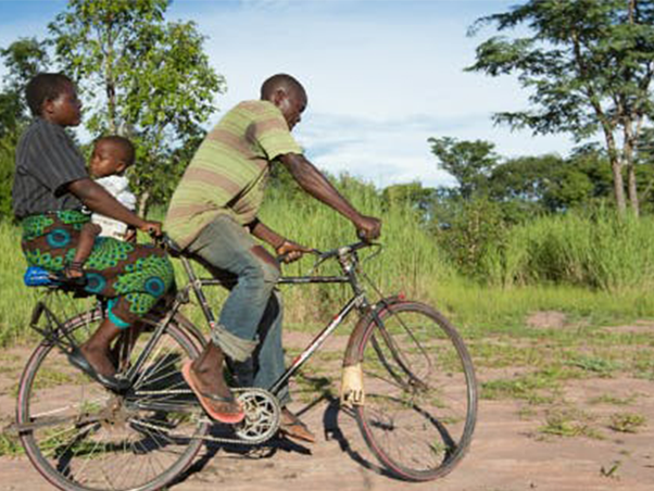 Man, woman and child riding a bicycle in Africa