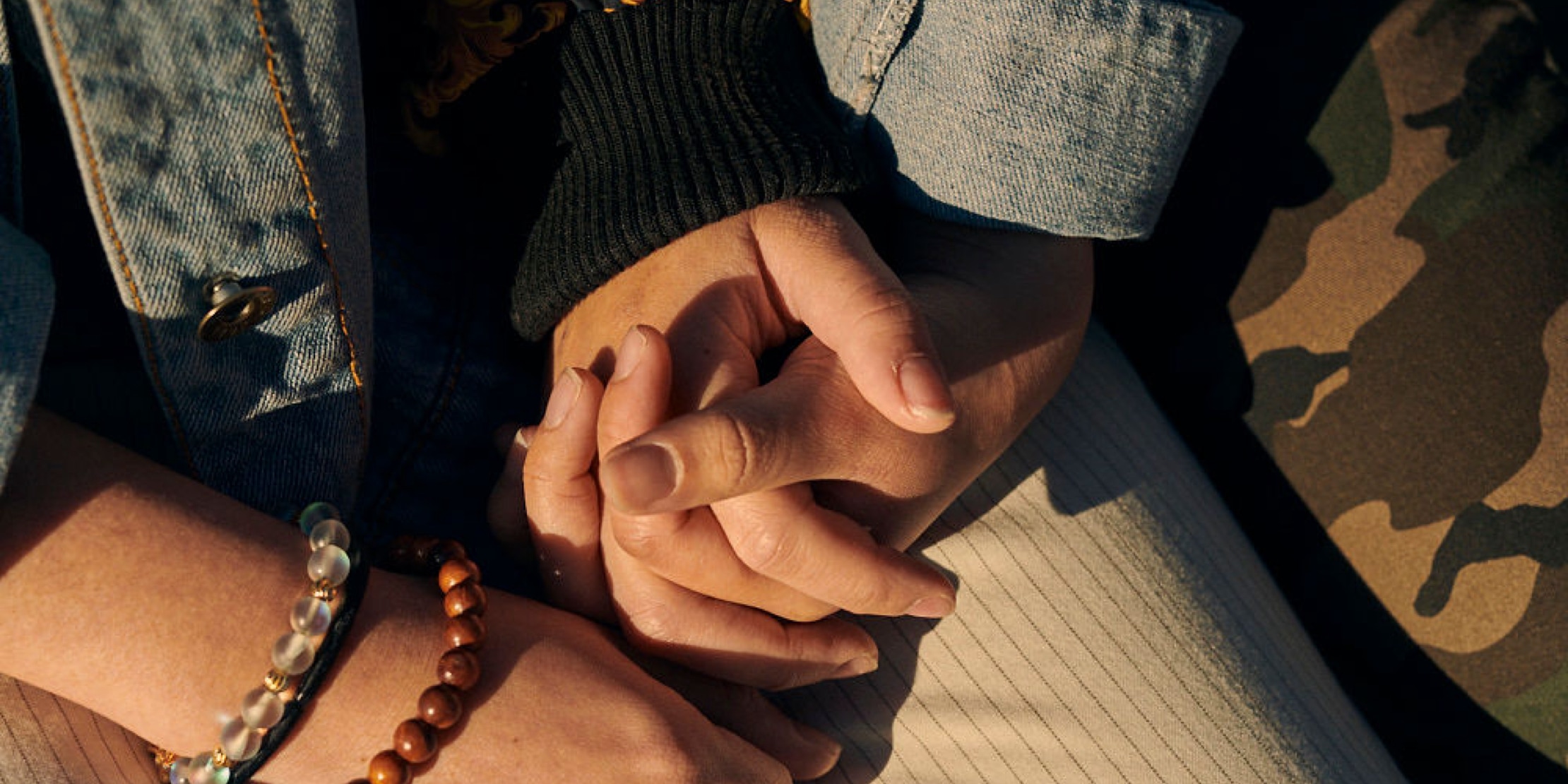 Close of up two people holding hands 